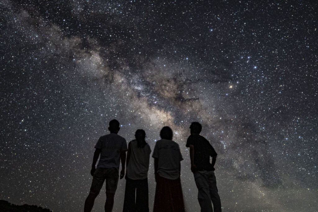 Group of friends watching the Milky Way at Nagareboshi no Oka stargazing tour, Ishigaki Island