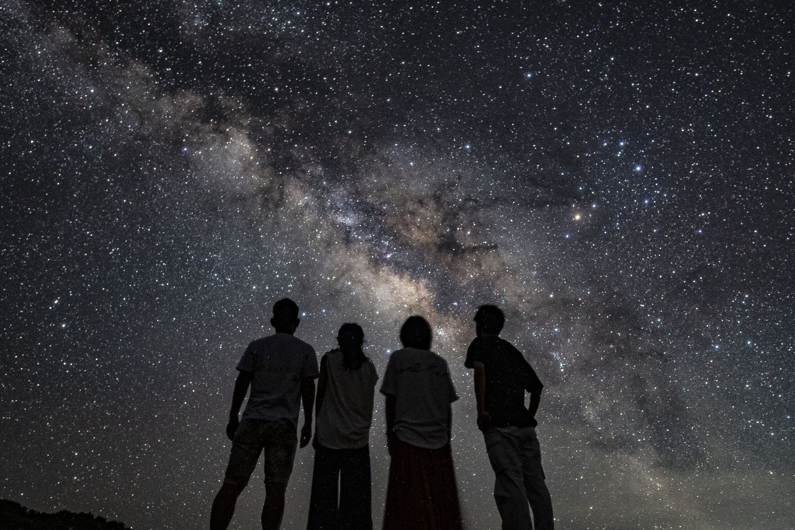 Group of friends watching the Milky Way at Nagareboshi no Oka stargazing tour, Ishigaki Island