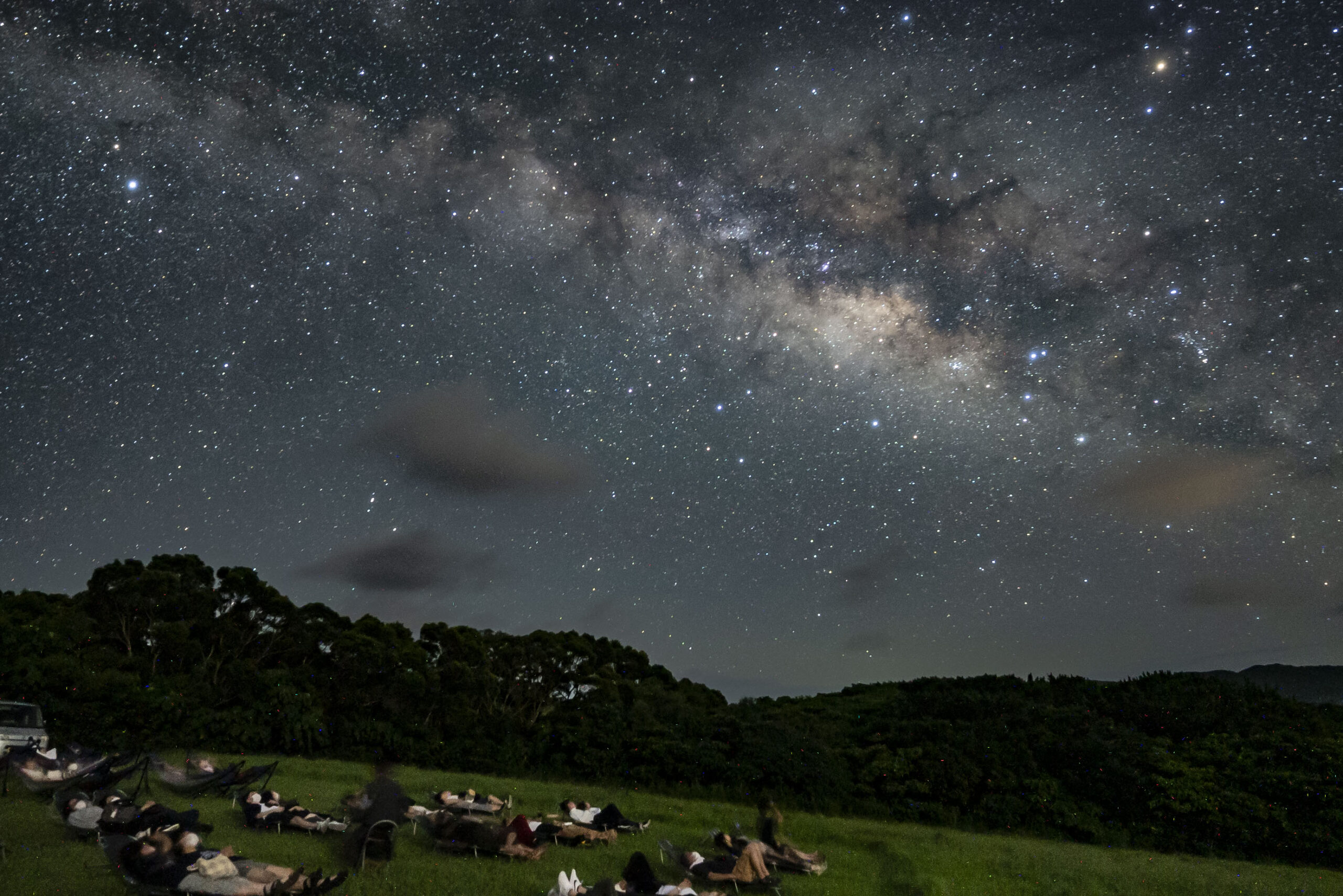 Guests lying on recliners watching the Milky Way at glamping area, Nagareboshi no Oka, Ishigaki Island